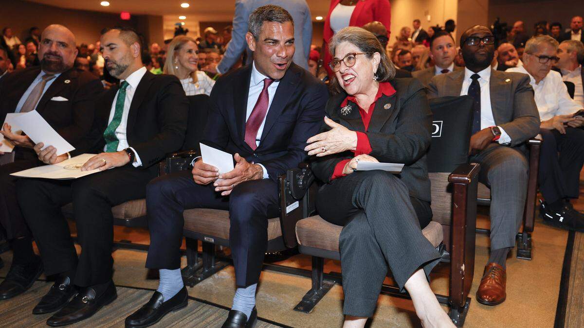 Miami Mayor Francis Suarez, at left, and Miami-Dade County Mayor Daniella Levine Cava, right, in attendance during the installation ceremony for Eileen Higgins as the Mayor of the City of Miami at the Miami-Dade College Wolfson Campus Auditorium in Miami, Florida, on Thursday, December 18, 2025. 