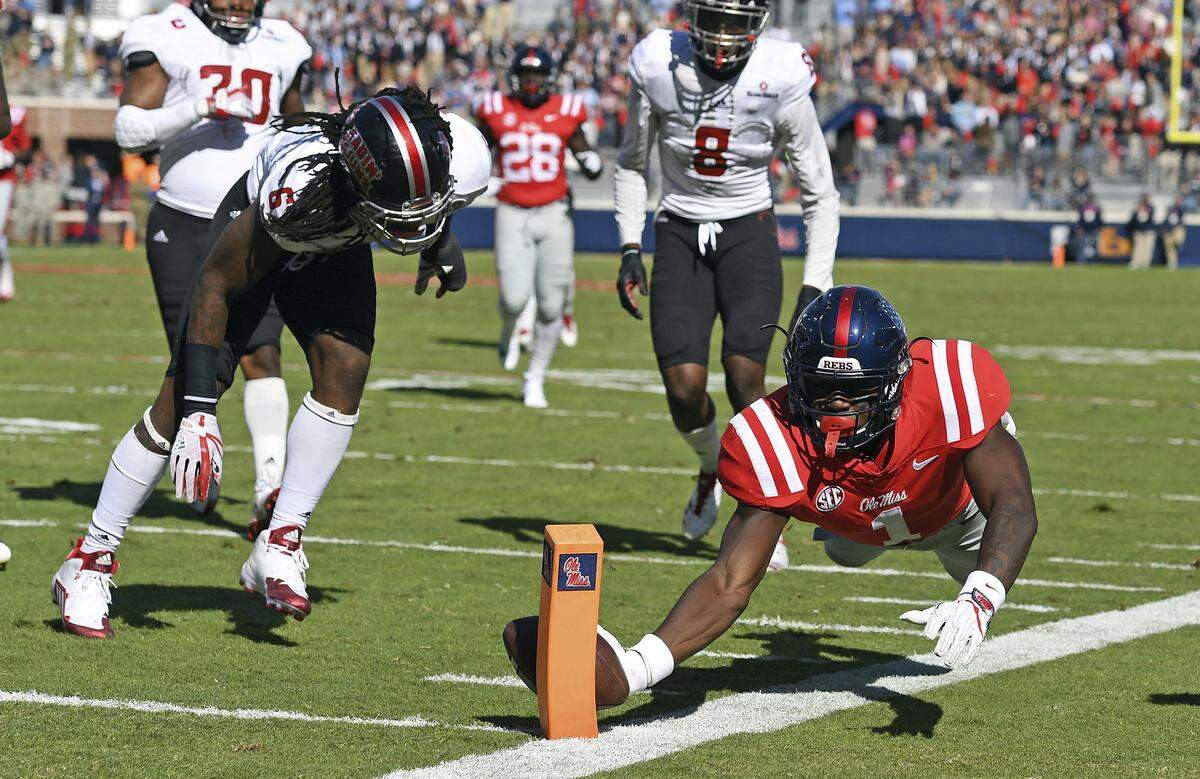Mississippi wide receiver A.J. Brown (1) dives into the end zone to score a touchdown past Louisiana-Lafayette defensive back Corey Turner (6) during the first half of an NCAA college football game in Oxford, Miss., Saturday, Nov. 11, 2017. (AP Photo/Thomas Graning)