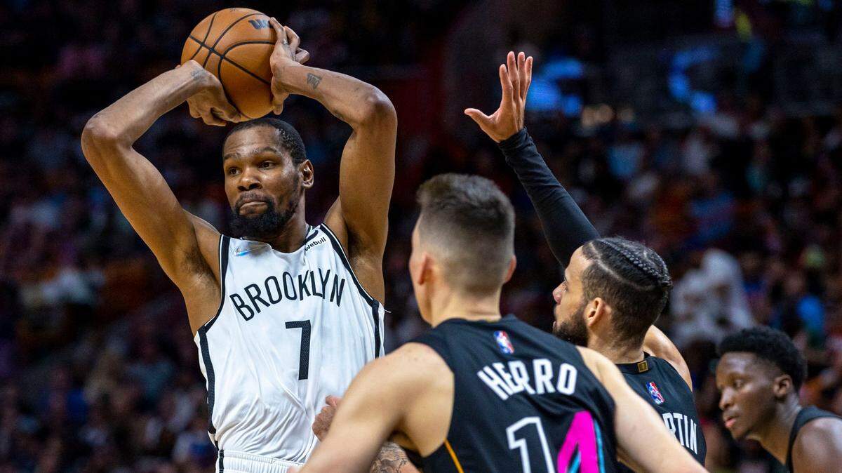 Brooklyn Nets forward Kevin Durant (2) passes while defended by Miami Heat forward Caleb Martin (16) during the fourth quarter of an NBA game at FTX Arena in Downtown Miami, Florida, on Saturday, March 26, 2022.