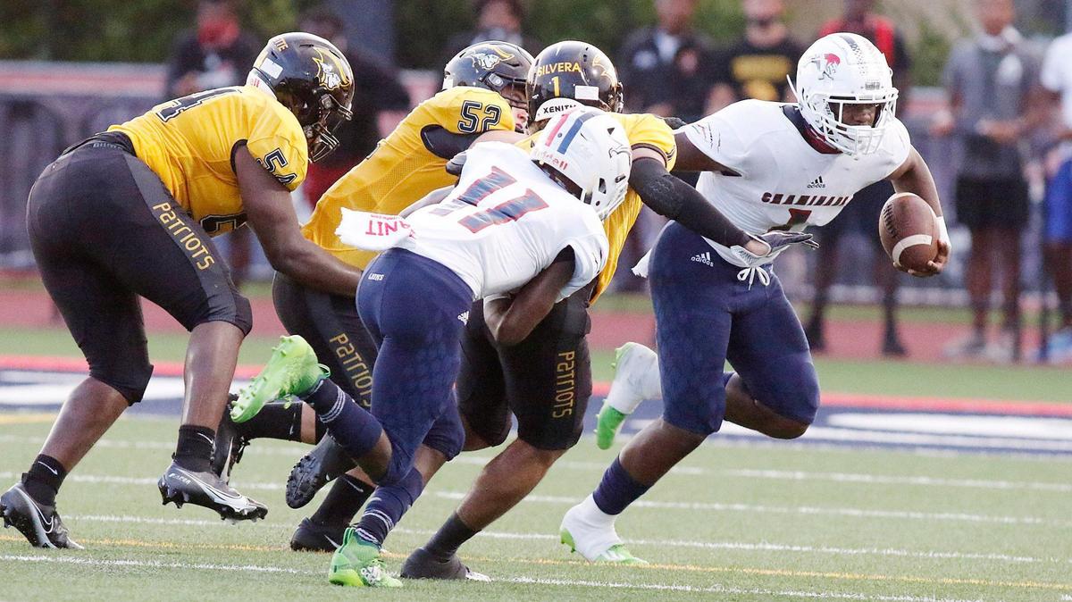 Chaminade-Madonna Lions running back Thaddius Franklin (1) attempts to escape American Heritage Patriots defenders during the football game Friday, September 17, 2020 in Hollywood