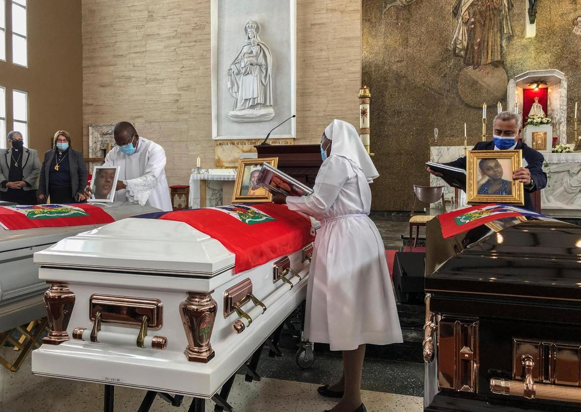 Church officials set up photos of the 11 Haitian women who died last month when the overloaded boat they were in capsized, at a church in San Juan, Puerto Rico, Wednesday, June 15, 2022.