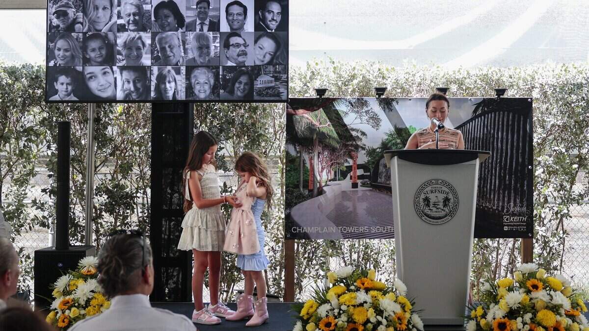 Sisters Scarlett, 9, left, and Sloane, 7, play with a dress their grandmother bought five years ago as their mother, Rachel Spiegel, right, remembers her mother, who died in the Champlain Towers South collapse.

The Town of Surfside held its 5th Annual Remembrance event on Wednesday, June 24, 2026, honoring the 98 people killed in the Champlain Towers South building collapse in Surfside, Florida.