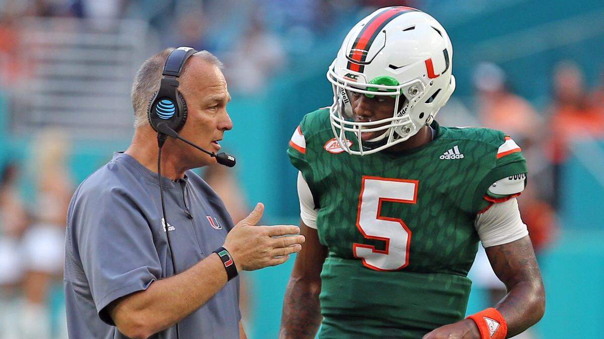 MIami Hurricanes Mark Richt talks with quarterback N’Kosi Perry during the spring game. Perry hasn’t been able to overtake senior Malik Rosier so far this offseason.