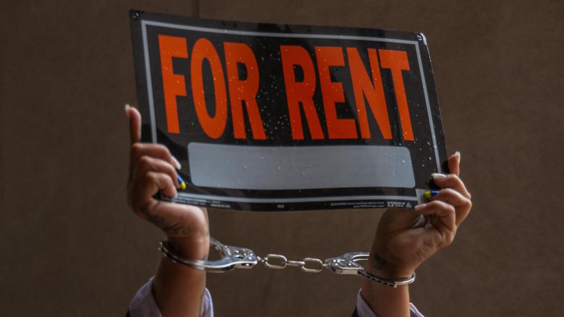Lily Vasquez, of the non-profit WYN Women, is photographed hand-cuffed and in the jail attire in protest of high rents and the lack of affordable housing. The fair housing advocates from Miami Coalition to Advance Racial Equity, Struggle for Miami’s Affordable and Sustainable Housing (SMASH), and others rally in protest of high rents and for affordable housing ahead of the county commission meeting at County Hall in downtown Miami, Florida on Tuesday, March 15, 2022.
