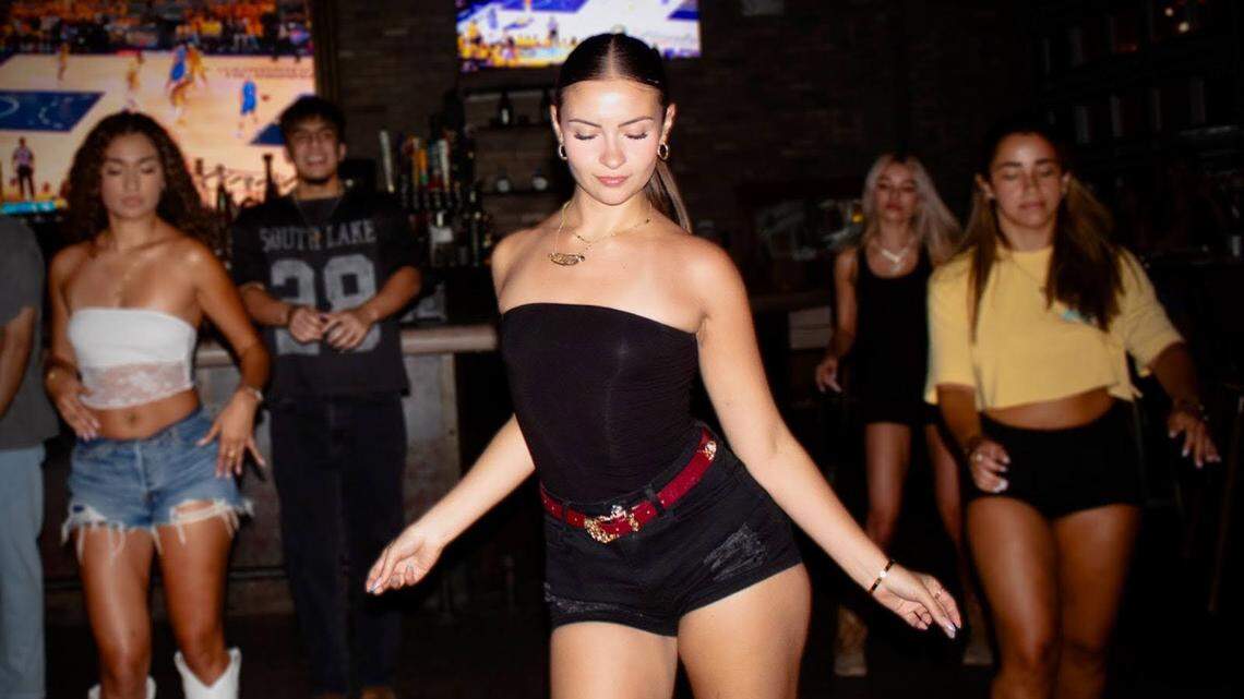 Nicole Castro leading the crowd during a line dance at Copper Blues in Doral.