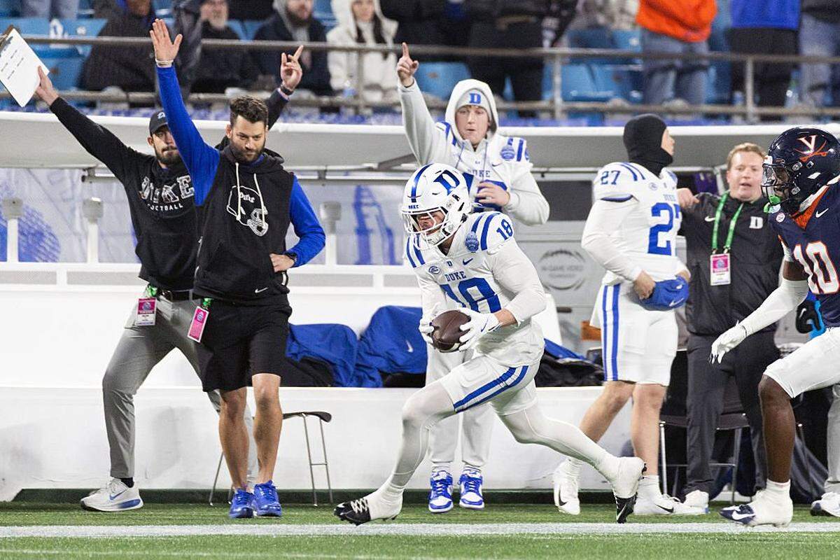 CHARLOTTE, NORTH CAROLINA - DECEMBER 6: Cooper Barkate #18 of the Duke Blue Devils catches a pass in front of Ja'Son Prevard #10 of the Virginia Cavaliers in the second half during a game at Bank of America Stadium on December 6, 2025 in Charlotte, North Carolina. (Photo by Ryan M. Kelly/Getty Images)