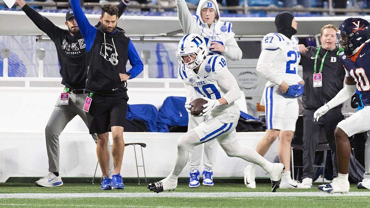 CHARLOTTE, NORTH CAROLINA - DECEMBER 6: Cooper Barkate #18 of the Duke Blue Devils catches a pass in front of Ja'Son Prevard #10 of the Virginia Cavaliers in the second half during a game at Bank of America Stadium on December 6, 2025 in Charlotte, North Carolina. (Photo by Ryan M. Kelly/Getty Images)