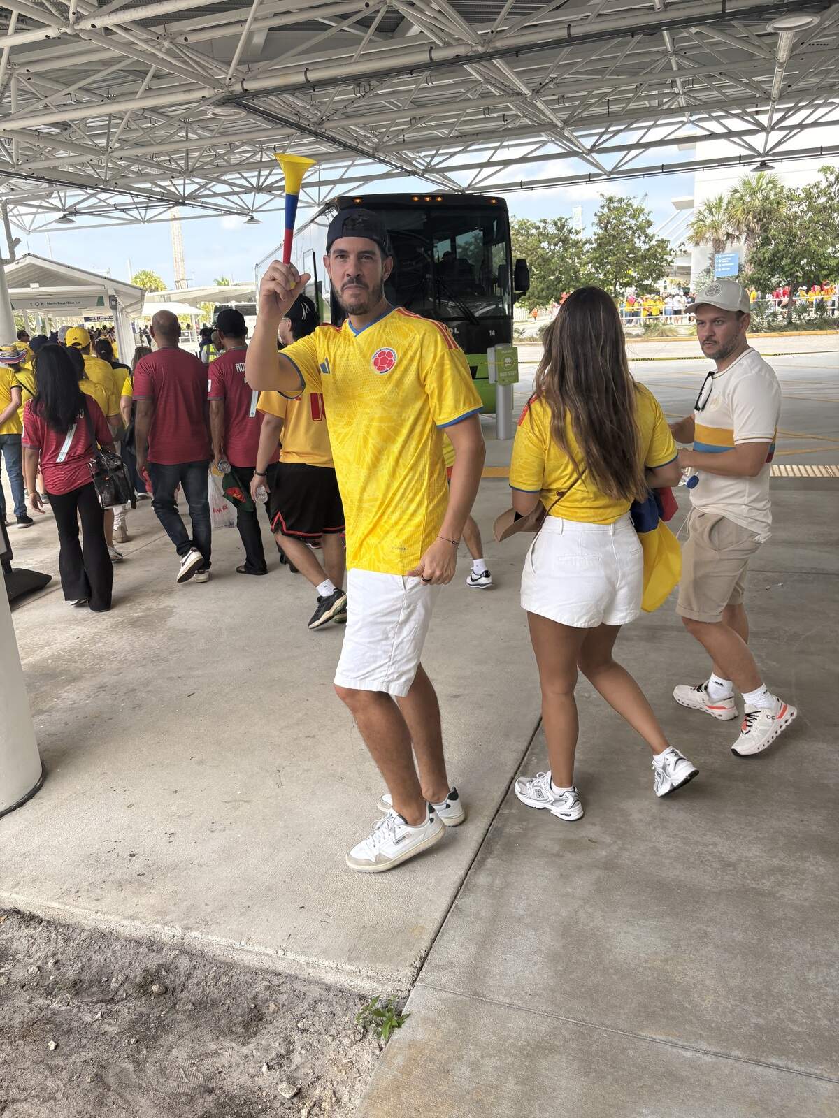 Javier Ocampo blows his vuvuzela on his way to boarding a stadium shuttle at the Golden Glades transit hub. He’s on vacation from Colombia.