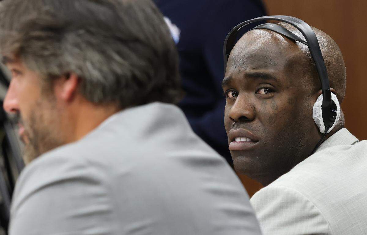 Cuban rapper Yosvanis “Chocolate MC” Sierra Hernandez sits next to his attorney Adolfo Gil during the first day of his trial for solicitation of first-degree murder as prosecutors presented their witness in Courtroom 7-4 at the Richard E. Gerstein Justice Building on Wednesday, November 12, 2025, in Miami, Florida. 