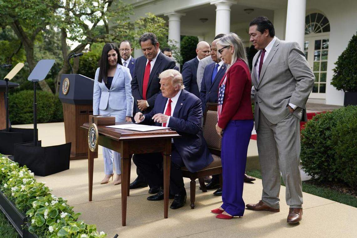 President Trump signs an executive order creating the White House Hispanic Prosperity Initiative on July 9.