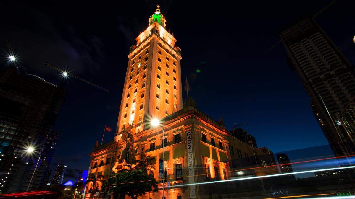 Freedom Tower in downtown Miami is illuminated to remember the over 4,500 Miami-Dade residents lost during the pandemic on Tuesday, January 19, 2021. The county joins cities and counties across the nation to honor the more than 400,000 people in the United States who lost their lives to COVID-19.