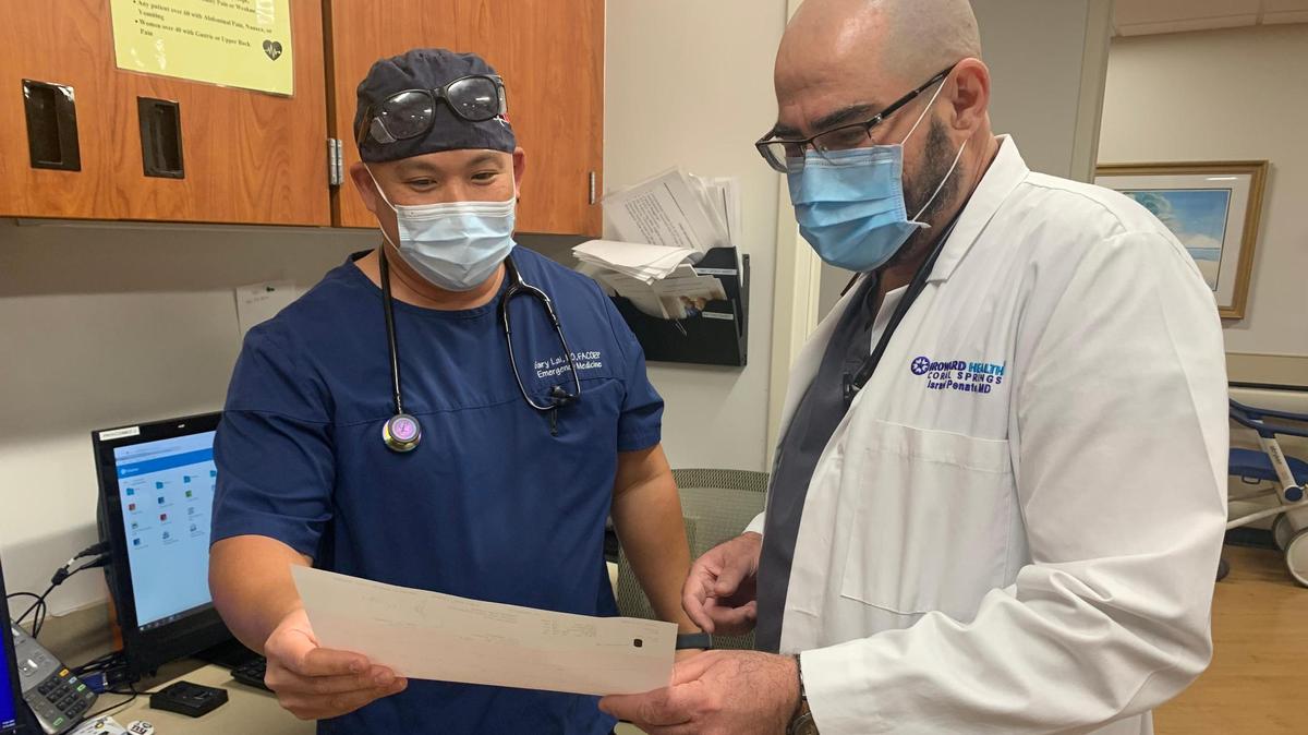 Dr. Israel Penate, right, chief of staff for Broward Health Coral Springs, consults with Dr. Gary Lai, emergency medical director at Broward Health Coral Springs.
