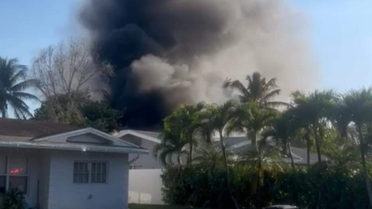 Smoke rises high in the air from a house fire in Fort Lauderdale Thursday night, April 17, 2025.