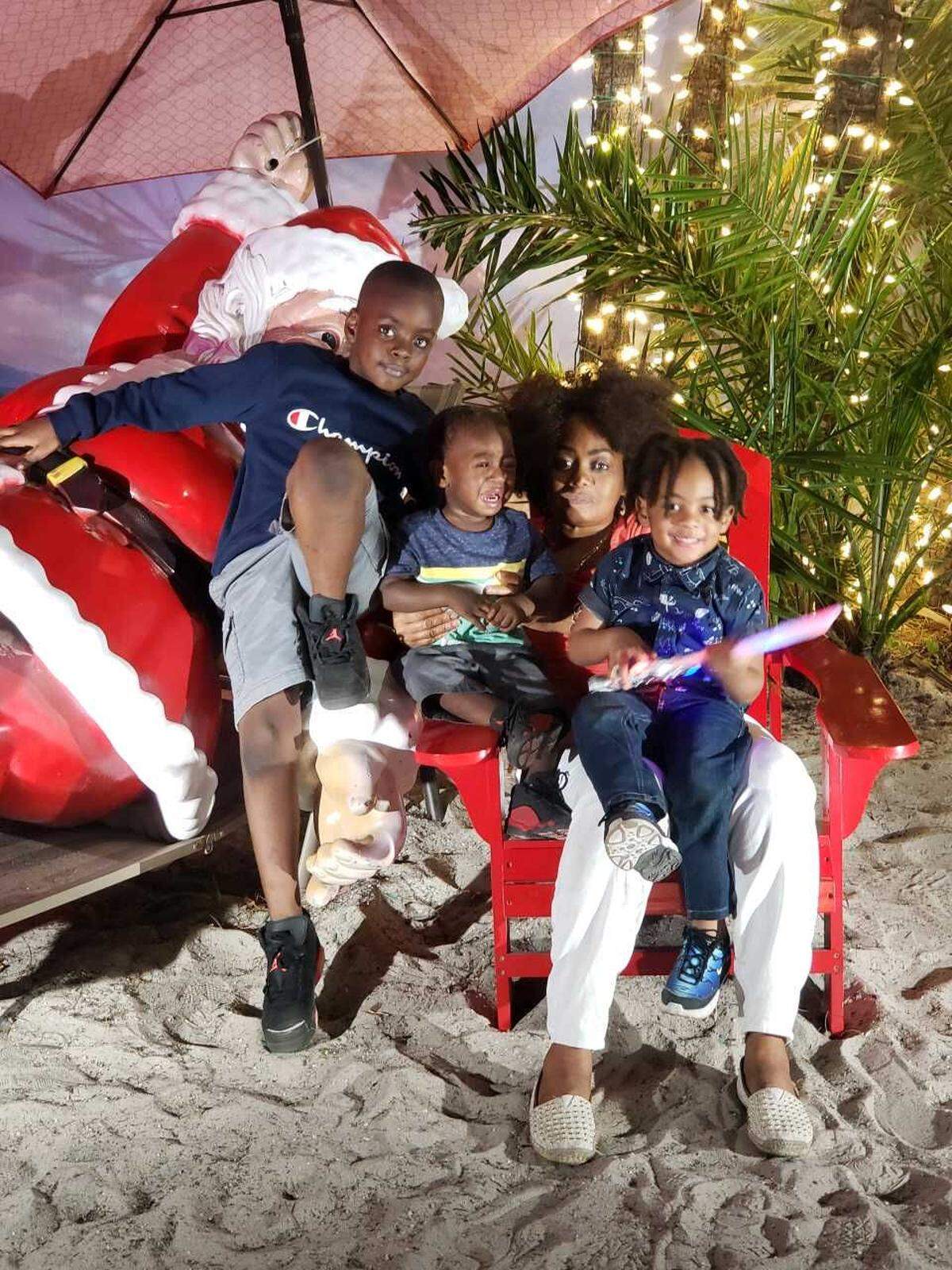 Elijah and his mom are in the middle, flanked by two of Elijah’s cousins at Santa’s Enchanted Forest. Elijah, returned to his family after he was taken at the hospital by the Florida Department of Children & Families, was crying because Santa scared him.