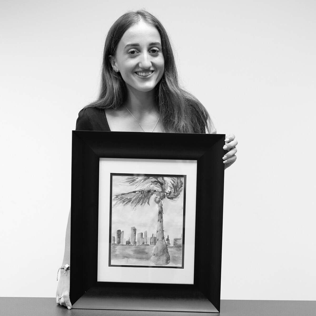 Coral Reef High School student Samantha Gonzalez won a $500 scholarship after competing in the South Florida Educational Federal Credit Union’s My Miami Holiday Art Contest. She is pictured holding her original artwork, “Serene Palms.”