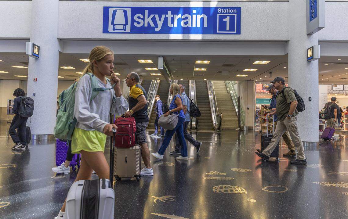 Passengers walked by the escalators heading to the MIA Skytrain recently opened Concourse D's station 1, as the Skytrain system service is fully restored ahead of Labor Day weekend in Miami, on Thursday, August 28, 2025.