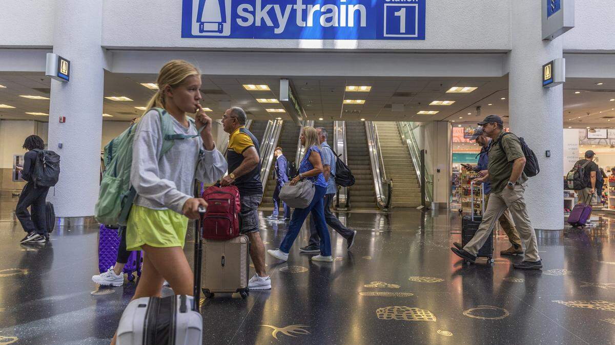 Passengers walked by the escalators heading to the MIA Skytrain recently opened Concourse D's station 1, as the Skytrain system service is fully restored ahead of Labor Day weekend in Miami, on Thursday, August 28, 2025.