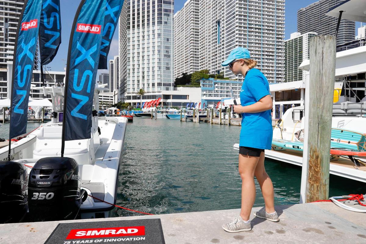 Manatee observer Heidi Hellenbrand looks for manatees in the vicinity of the Venetian Marina & Yacht Club during the Miami International Boat Show in downtown Miami, Florida, on Friday, Feb. 18, 2022. The Boat Show and Miami-Dade regulators disagree on manatee safety rules for the 2023 show.