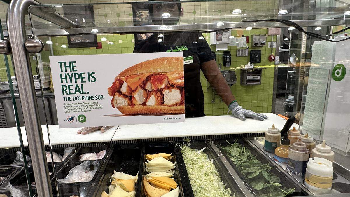 A Publix deli staffer at the Pinecrest supermarket is ready to pile on a Dolphins Sub on Sept. 6, 2025.