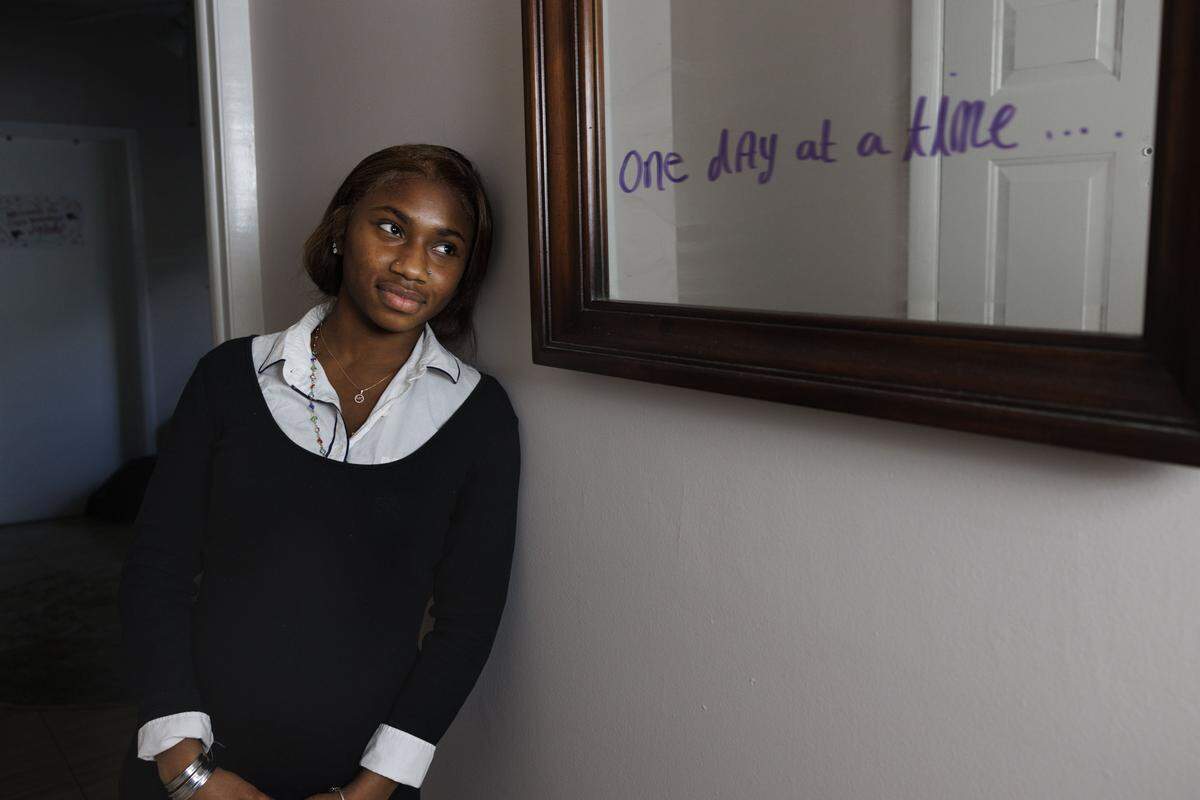 Ifetayo Frye, 19, poses inside her apartment that she shares with a roommate at Casa Valentino, a safe haven home for young people who have found themselves homeless, on Tuesday, Dec. 16, 2025, in Miami, Fla. Frye writes motivational quotes and bible verses around her apartment to stay positive.