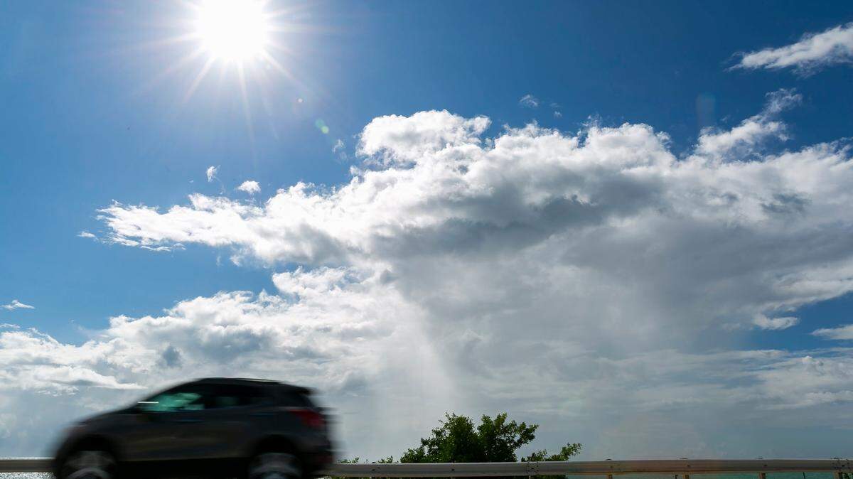 Cars make their way down the Overseas Highway near the Channel 2 Bridge in Islamorada, Florida in this file photo from Oct. 12, 2021. Expect sunny skies like this for the week starting May 13, 2022, with just a chance of showers, according to the National Weather Service in Key West.