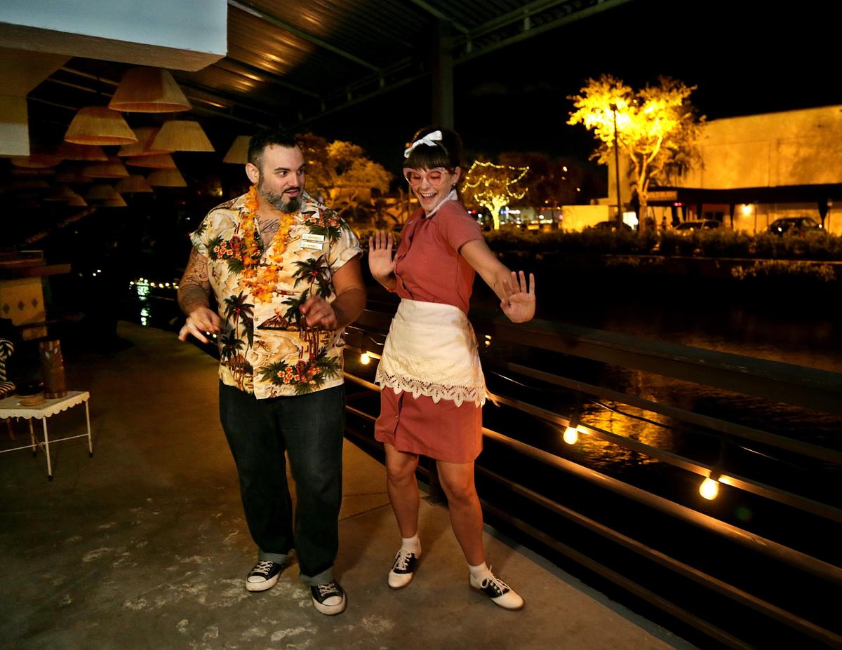 Actors Coley Campany as Barbara Kim and Jeff Quintana as “The Bartender,” take a swing in the Tiki bar as they rehearse a short play featured in “Miami Motel Stories: MiMo” by playwright Juan C. Sanchez.
