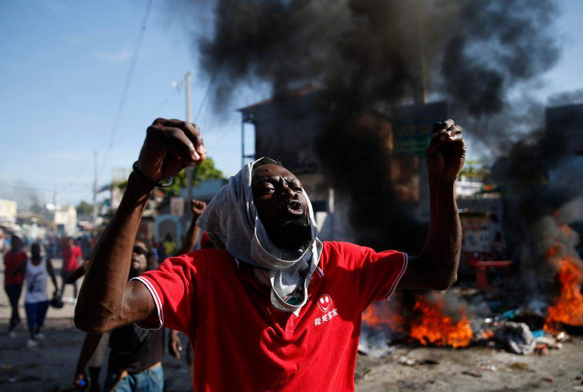An anti-government protester shouts that Haitian President Jovenel Moïse must step down, in Port-au-Prince, Haiti, Monday, Oct. 7, 2019.