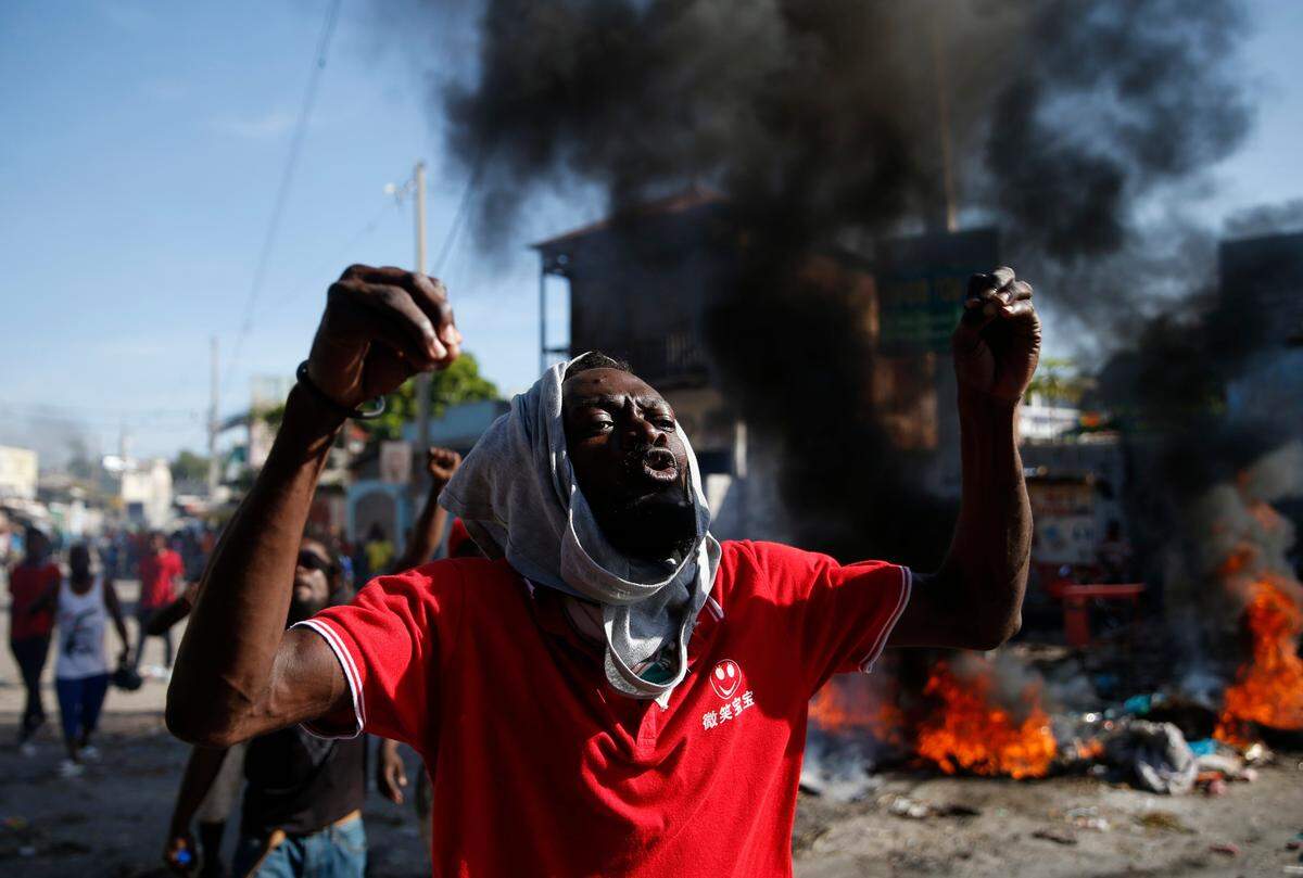 An anti-government protester shouts that Haitian President Jovenel Moïse must step down, in Port-au-Prince, Haiti, Monday, Oct. 7, 2019.