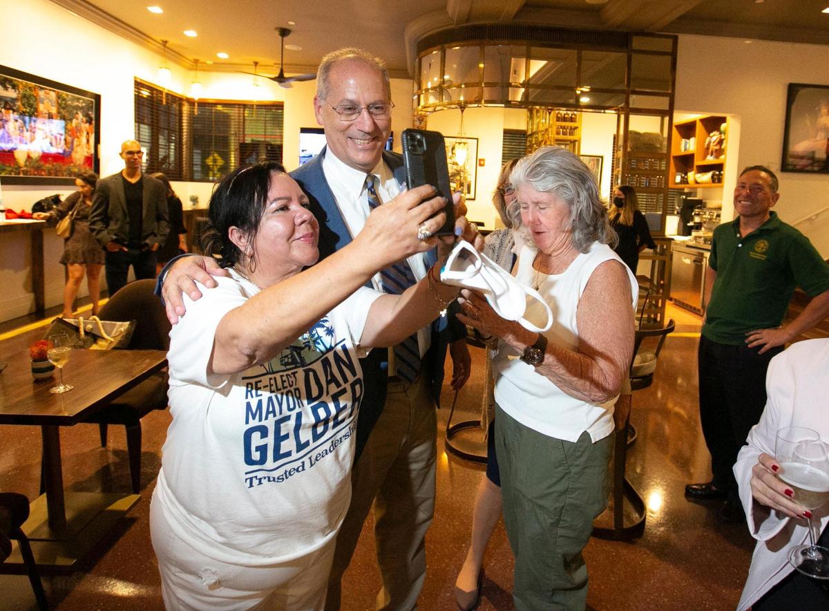 Campaign worker Liliana Martinez snaps a photo with Miami Beach Mayor Dan Gelber at his re-election party at the Betsy Hotel, Miami Beach, Tuesday, November 2, 2021.
