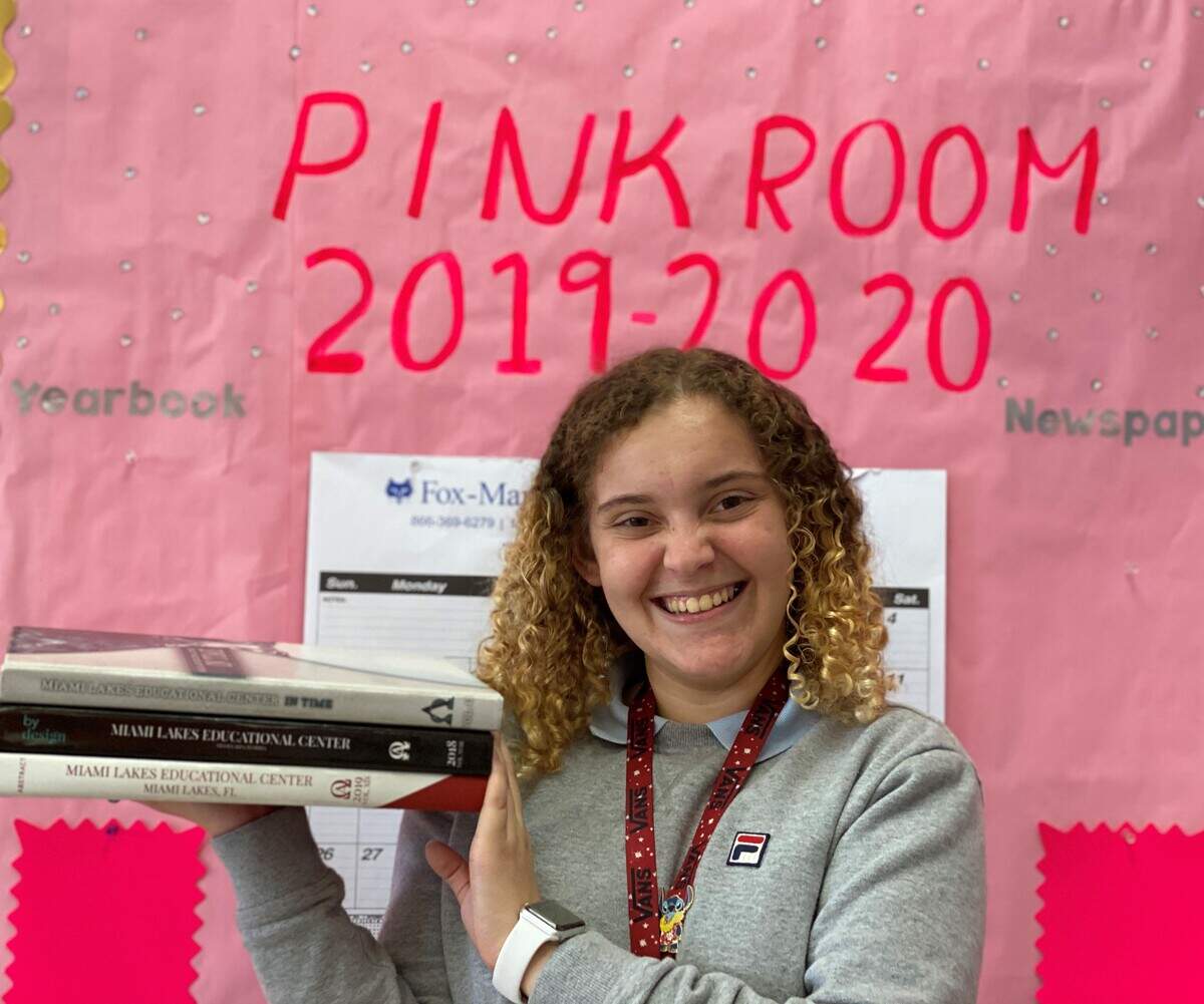 Yasmine Mezawi, editor-in-chief of the Miami Lakes Education Center’s 2020 yearbook, holds past editions. The coronavirus pandemic has stripped graduating seniors like her of milestones like prom and graduation.