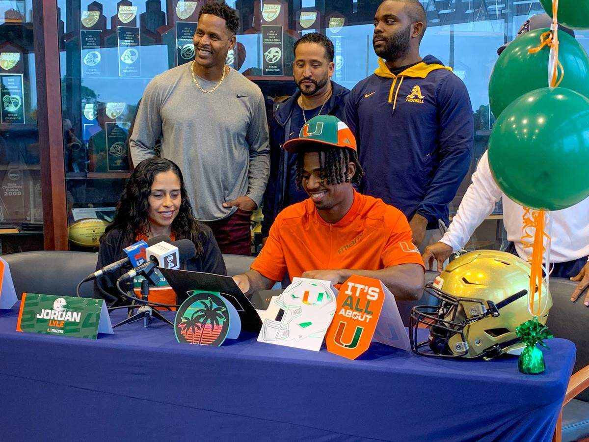St. Thomas Aquinas running back Jordan Lyle smiles after signing a national letter of intent with the Miami Hurricanes on Wednesday, Dec. 20, 2023.