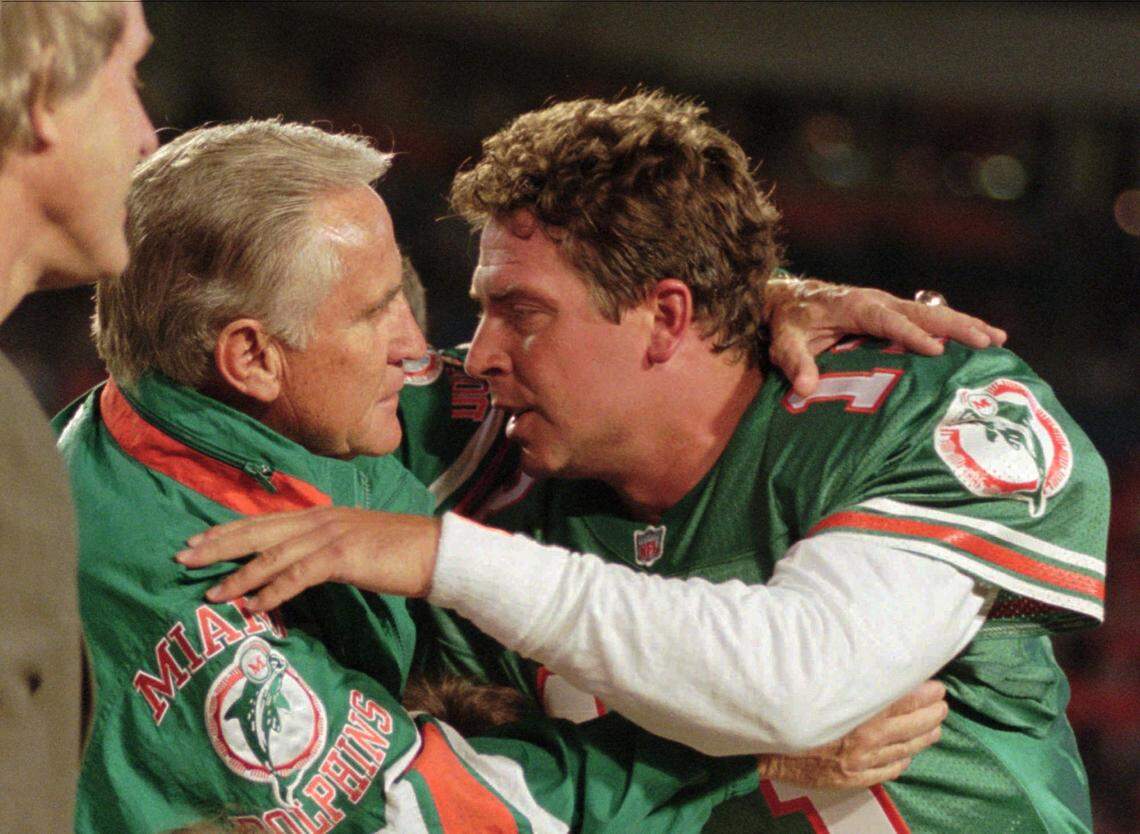 Miami Dolphins’ coach Don Shula, left, gives Dolphins quarterback Dan Marino a congratulatory hug as Marino was honored Monday night, Dec. 11, 1995 for breaking three standing passing records previously held by Minnesota Vikings quarterback Fran Tarkenton.