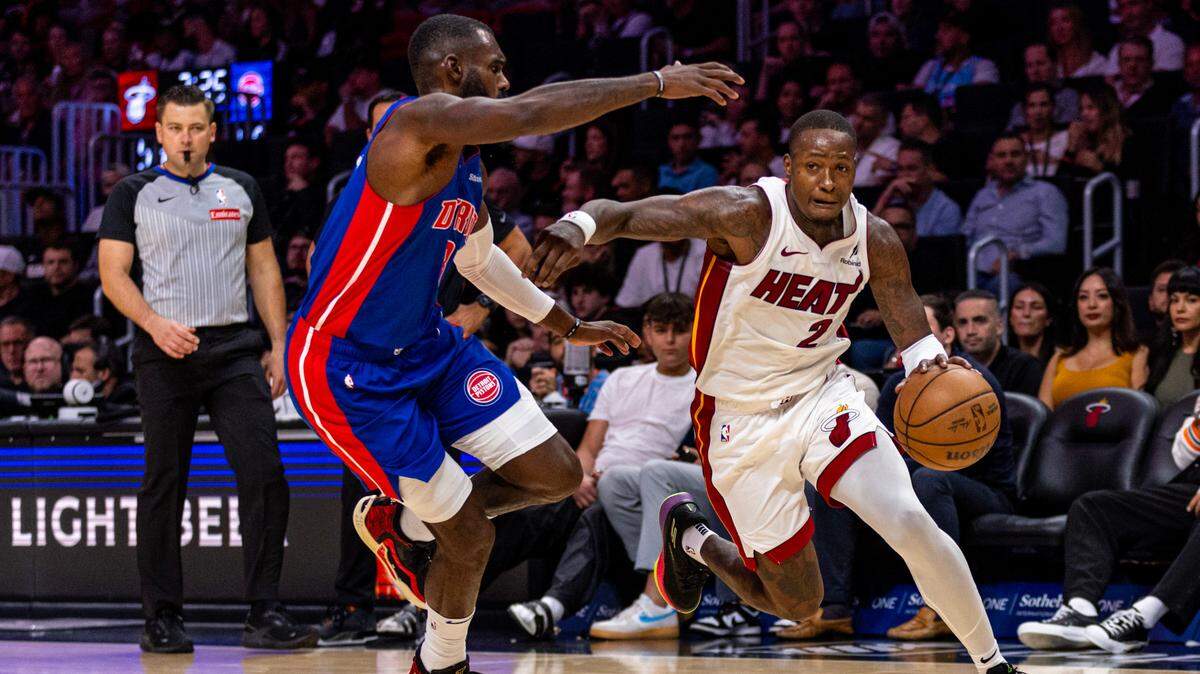 Miami Heat guard Terry Rozier (2) drives past Detroit Pistons forward Tim Hardaway Jr. (8) during an NBA game at Kaseya Center on October 28, 2024, in Miami.