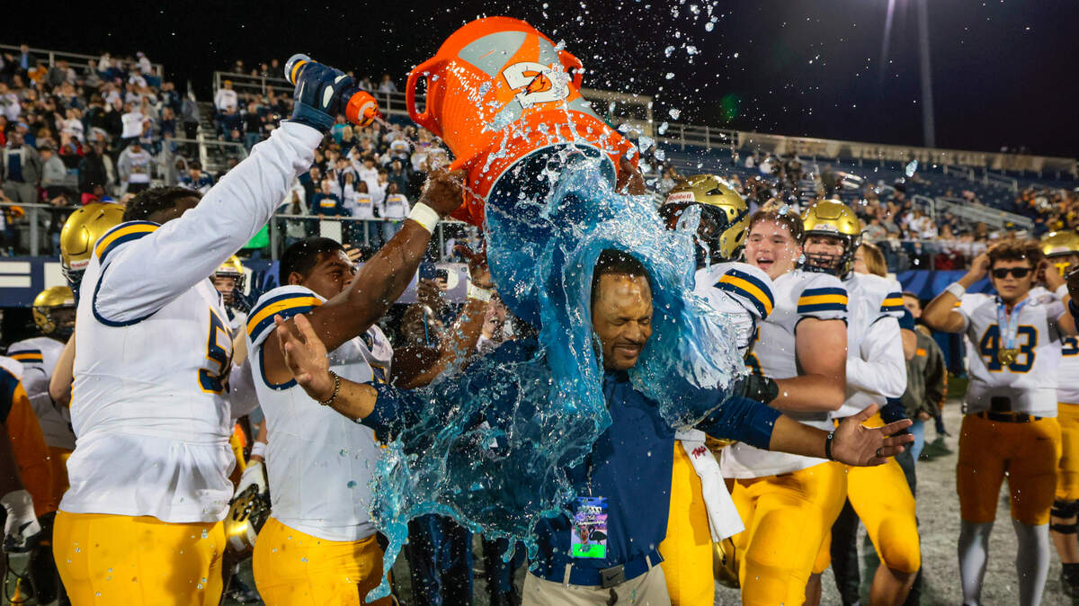 St. Thomas Aquinas head coach Roger Harriott doused with a bucket of Gatorade by players after Aquinas wins the game against Lakeland Dreadnaughts during the Florida High School Football State Championships - Class 5A game at Pitbull Stadium on the campus of Florida International University in Miami, Florida, on Thursday, December 12, 2024.