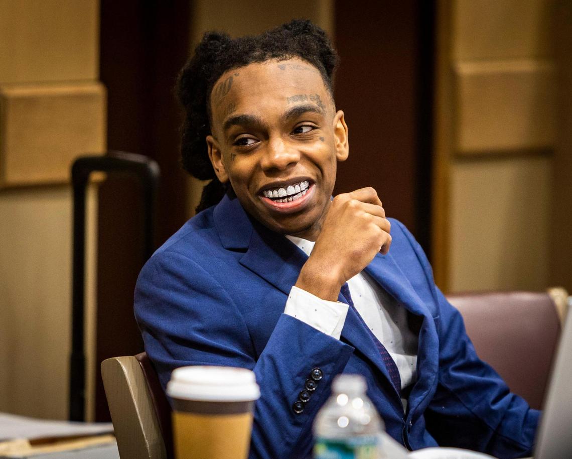 Fort Lauderdale, Florida - June 9, 2023 - Jamell Maurice Demons, known professionally as YNW Melly, smiles as he talks to a member of his defense team just before opening statements began at his trial for murder in Fort Lauderdale criminal court.