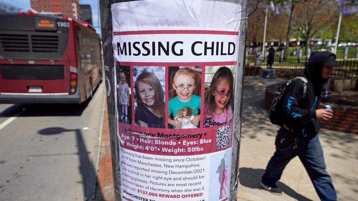 A man walks past a “missing child” poster for Harmony Montgomery on May 5 in Manchester, New Hampshire.