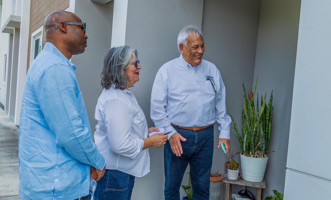 North Miami mayoral candidate Hector Medina with campaign manager Wancito Francis (far left) and his wife Alina Medina, campaigns door to door in North Miami.