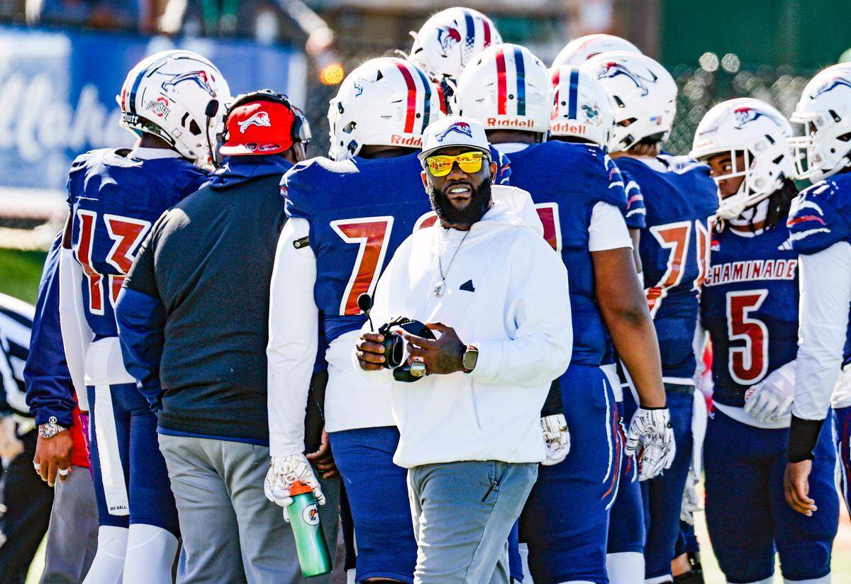 Chaminade-Madonna Lions coach Dameon Jones works with players against the Clearwater Central Catholic Marauders in the Class 1M, Region 3, District 6, State Championship game at Bragg Memorial Stadium in Tallahassee, Florida, on Thursday, December 7, 2023.