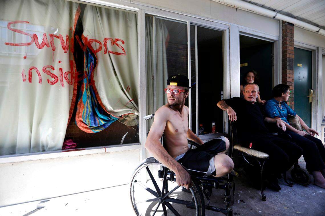 Wes Allen Jr., left, sits with his father, Wes Allen Sr., sister Alison and mother, Vicki, outside their room at a damaged motel in Panama City six days after Michael hit the Panhandle. Many residents rode out the storm in motels and have no place to go even though rooms may be heavily damaged.
