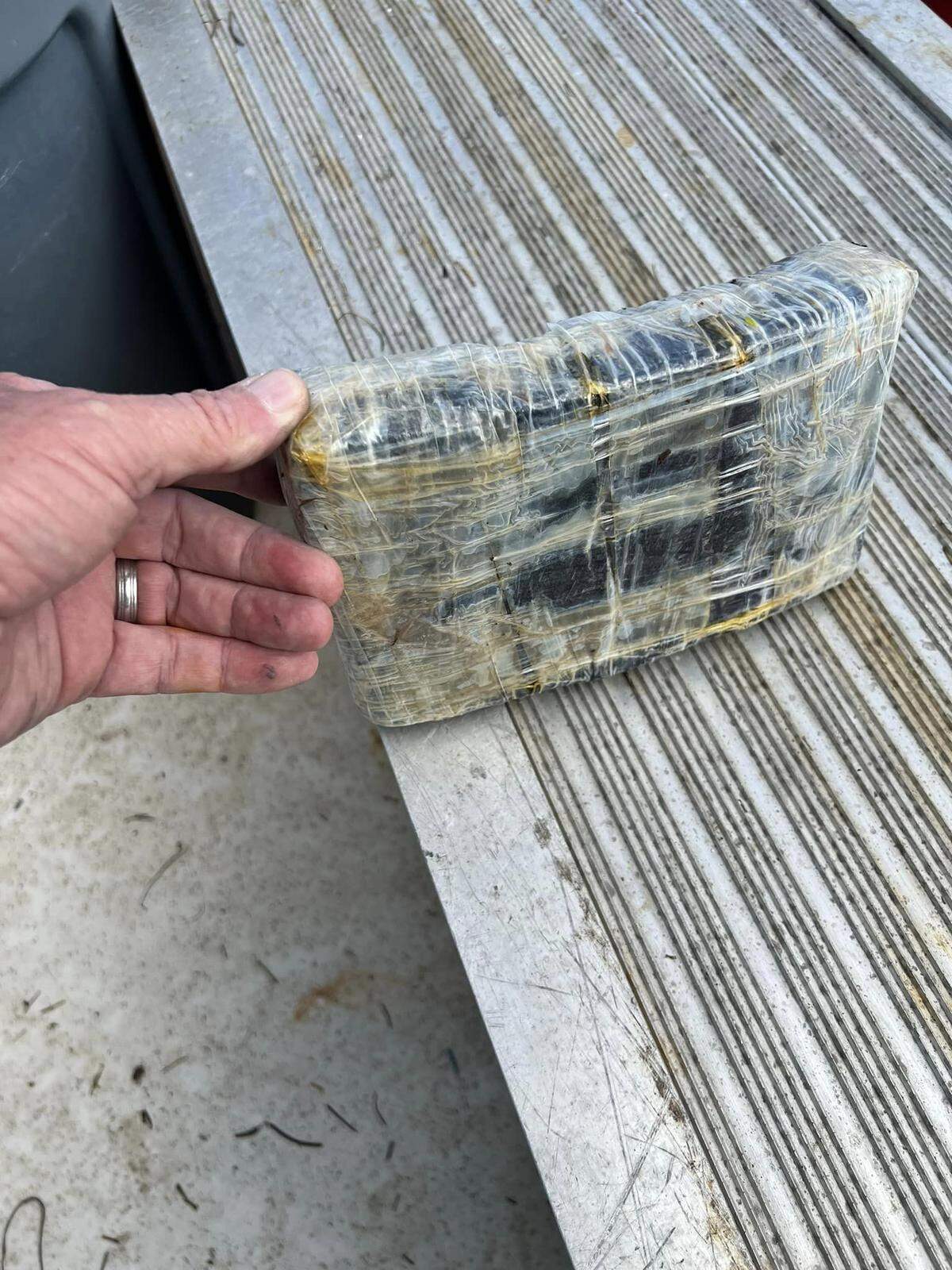 A brick of cocaine found by volunteers cleaning trash in the mangroves of Big Pine Key Monday, Jan. 29, 2024, is displayed on a table.