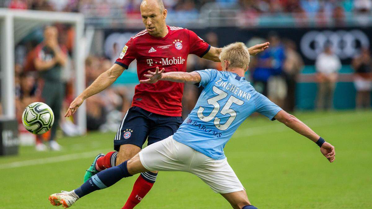 El astro del Bayern Munich Arjen Robben (10) trata de evadir a su marcador del Manchester City, Oleksandr Zinchenko (35),  en el partido de este 28 de julio por la  International Champions Cup m en el Hard Rock Stadium en Miami Gardens.