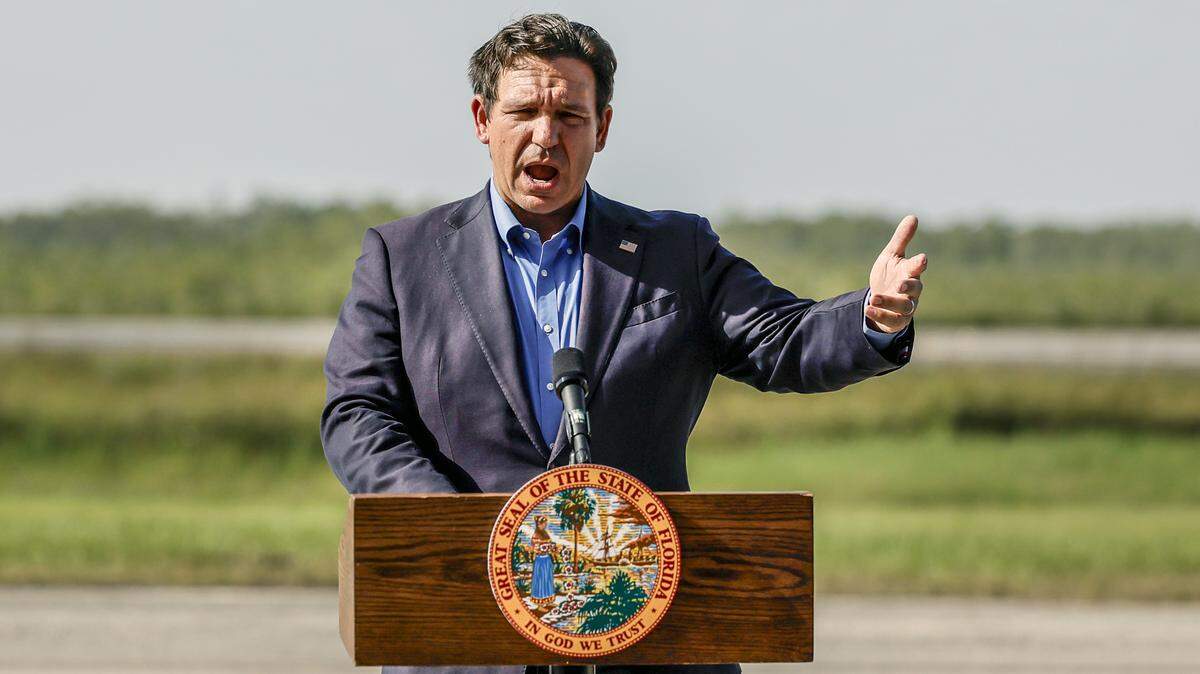 Gov. Ron DeSantis speaks to reporters during a press conference on the airplane runway of Alligator Alcatraz in Ochopee on July 25, 2025. 