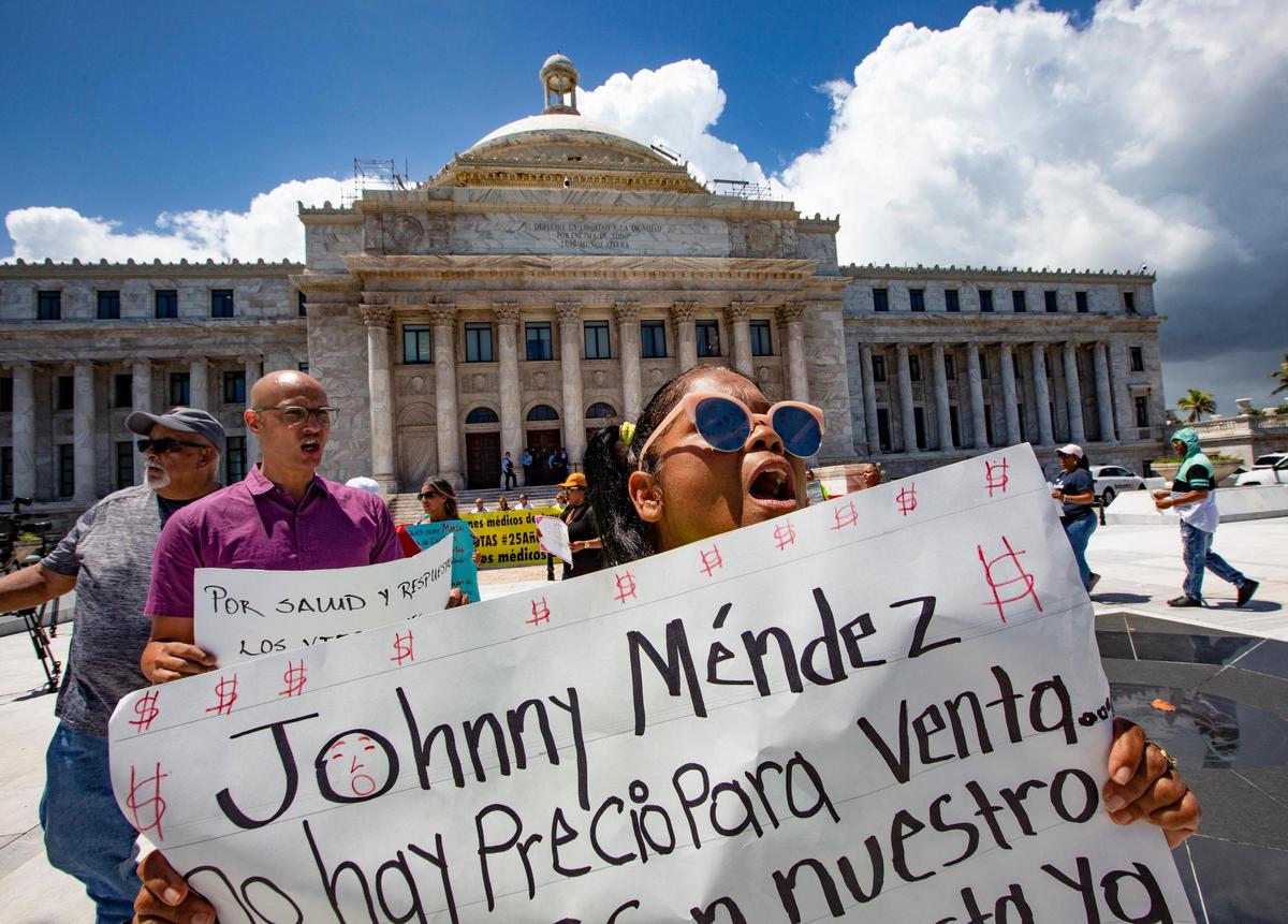 Demonstrator Margarita Santos Osorio yells in front of ‘El Capitolio,’ the capitol in San Juan, Puerto Rico, on Aug. 20, 2018. Osorio joined protesters seeking better medical treatment and facilities on the island of Vieques.