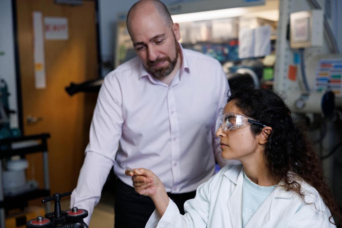 Dr. Bilal El-Zahab, left, supervises a demonstration of one of his PhD students, Saeme Motevalian, cutting a piece of sulfur at the Battery Research Laboratory on Thursday, March 20, 2025, at the FIU Engineering Center in Miami, Fla. Dr. El-Zahab’s laboratory has created a Lithium-sulfur battery that could replace Lithium-ion rechargeable batteries.