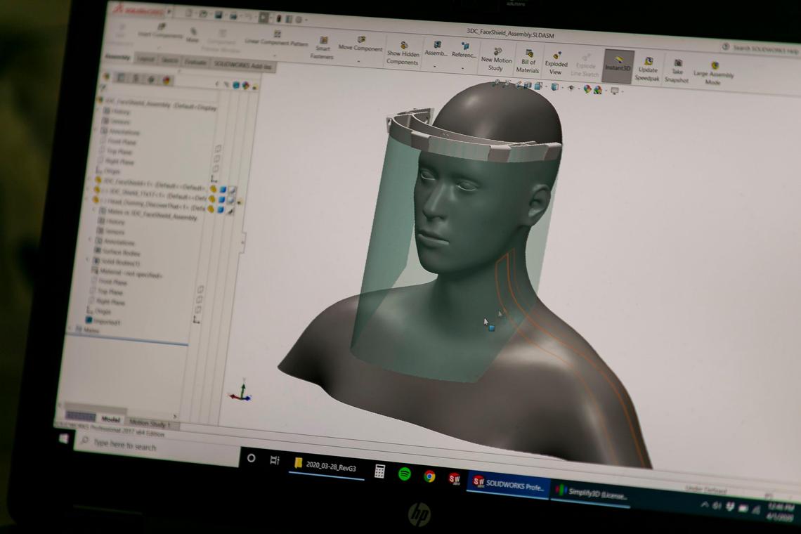 Alexander Hussain, the co-founder of 3D Chimera, looks at his design for a 3D-printed face shield at his office in Miami on March 1, 2020. Hussain is planning to sell the face shield to local hospitals to keep workers safe from the coronavirus.