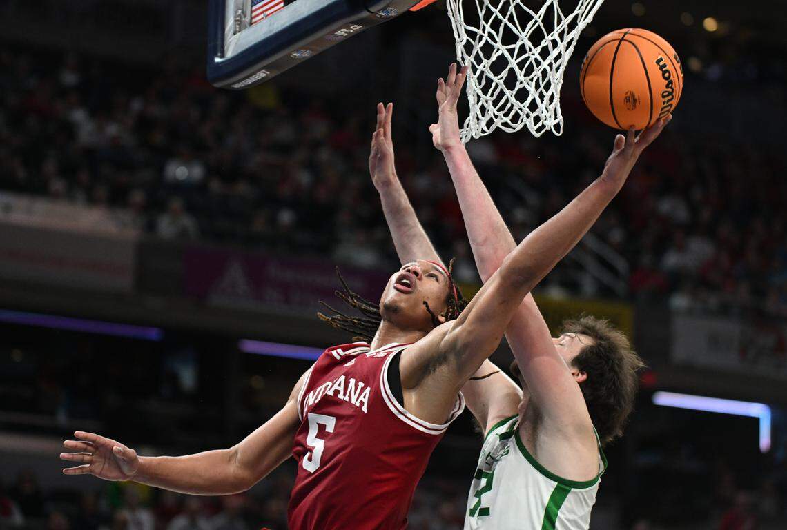 Mar 13, 2025; Indianapolis, IN, USA; Indiana Hoosiers forward Malik Reneau (5) shoots past Oregon Ducks center Nate Bittle (32) during the second half at Gainbridge Fieldhouse. Mandatory Credit: Robert Goddin-Imagn Images