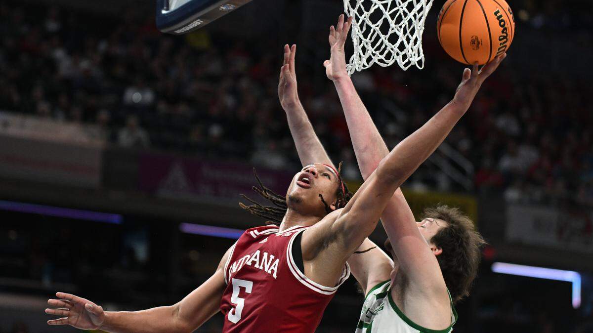 Mar 13, 2025; Indianapolis, IN, USA; Indiana Hoosiers forward Malik Reneau (5) shoots past Oregon Ducks center Nate Bittle (32) during the second half at Gainbridge Fieldhouse. Mandatory Credit: Robert Goddin-Imagn Images