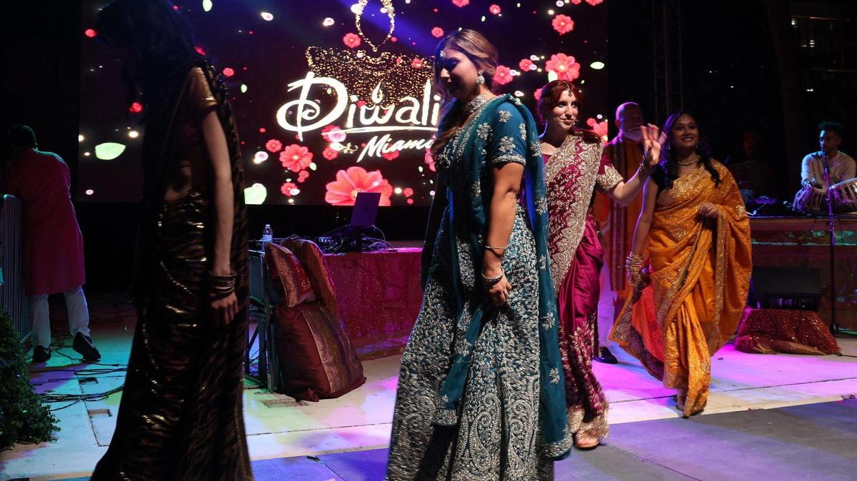 Models exit the stage Sunday while acknowledging the crowd after the Indian fashion showcase. South Florida Indian community celebrated the “Festival of Lights” during the Diwali Miami event at Oasis Wynwood with music, food, dancing, and traditional beverages of the Hindu holiday on Sunday, November 12, 2023.