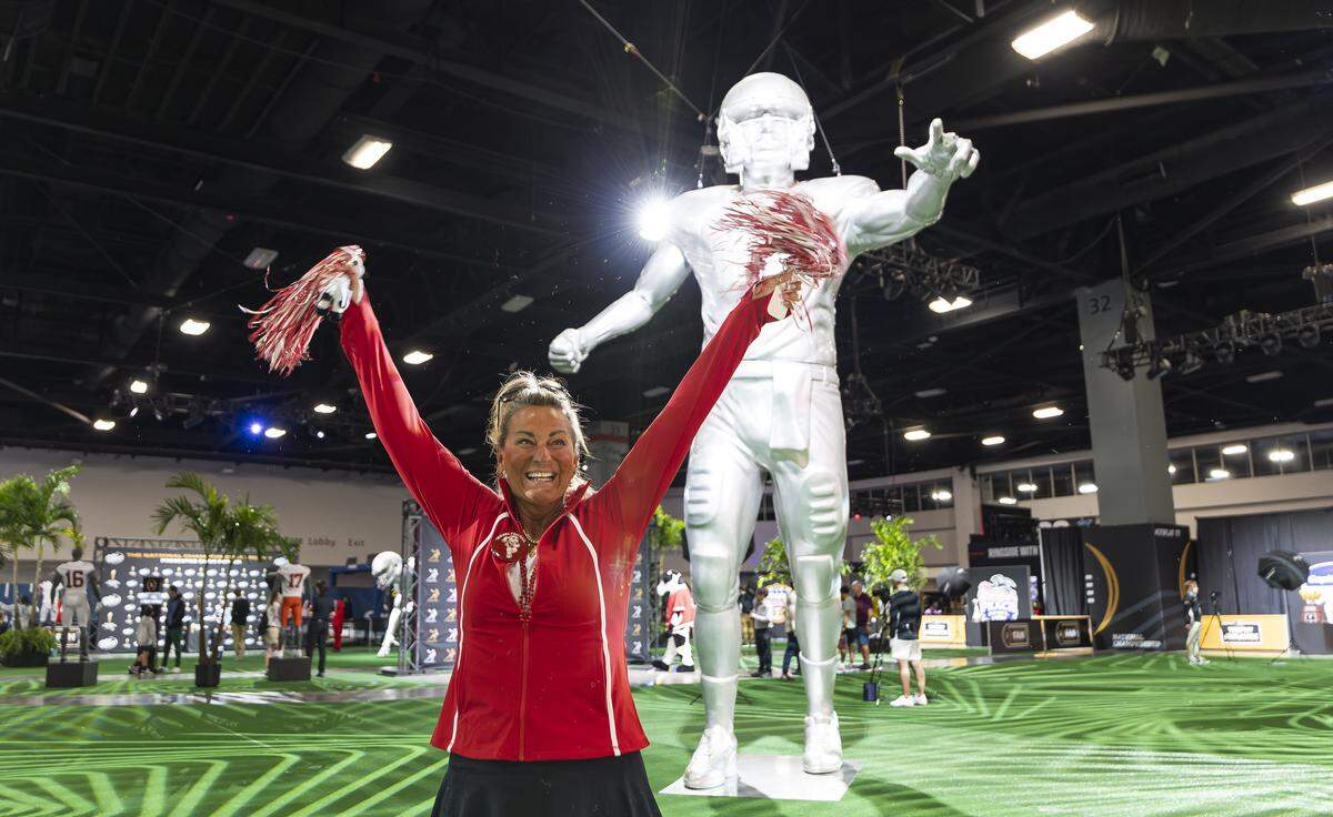 Lynda Thomas cheers as she visits the Playoff Fan Central at the Miami Beach Convention Center on Friday, Jan. 16, 2025, in Miami Beach, Fla. Fans can visit the event ahead of the College Football Playoff National Championship Game between the Miami Hurricanes and the Indiana Hoosiers and enjoy a variety of family-friendly interactive experiences.