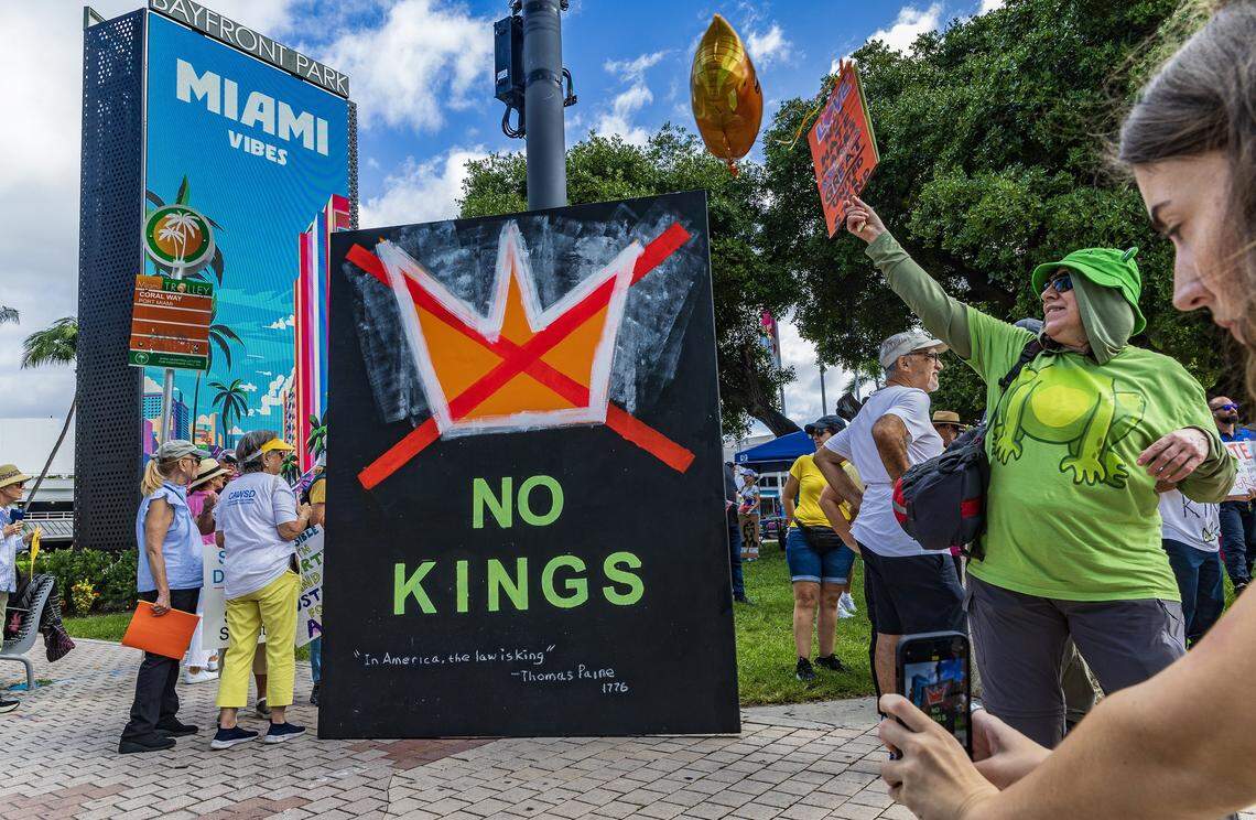 Protesters at the ‘No Kings’ anti-Trump protests. The woman on the right is wearing a frog costume as a tribute to the inflatable frog costumes worn by protestors in Portland, Oregon.  